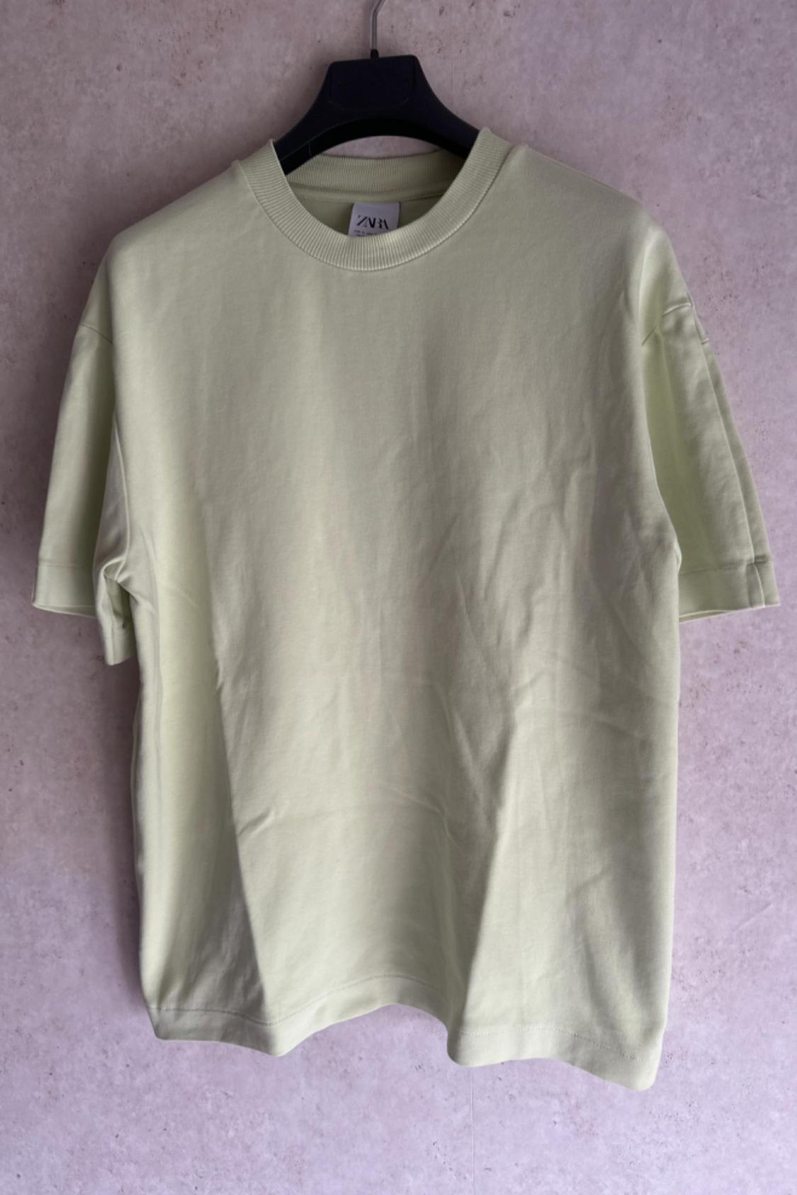 Front view of a light green crew neck t-shirt with short sleeves.