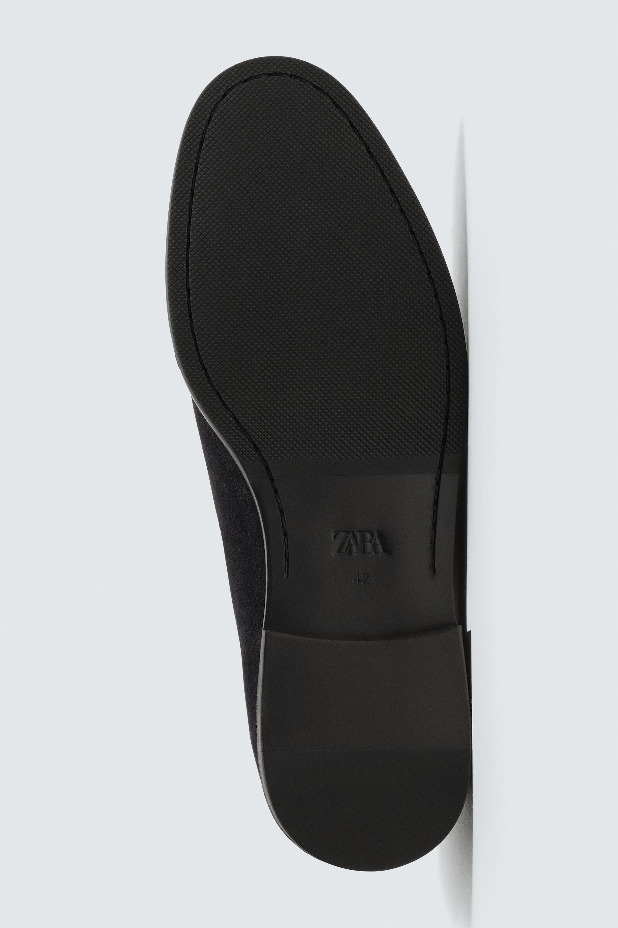 MOCASSINS EN CUIR À POMPONS