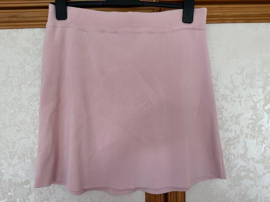 Front view of short pink skirt with elasticated waist.