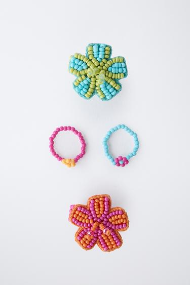 FOUR PACK OF FLOWER BEADED RINGS - Fuchsia by Zara