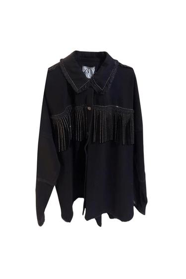 Front view of a black jacket with fringe and stud details on the chest and collar with frayed trim.