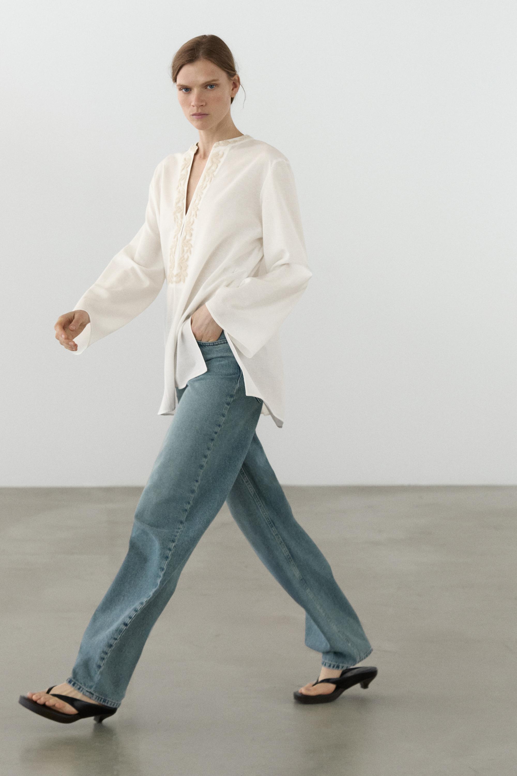 Flowing oversize blouse with stand collar and embroidery