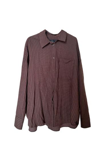 Brown long-sleeved shirt with vertical stripes. Features a collar, button fastening and a chest pocket with horizontal stripes.