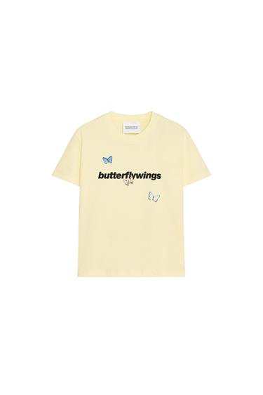 Front view of a yellow t-shirt with 'butterflywings' text and butterfly prints.