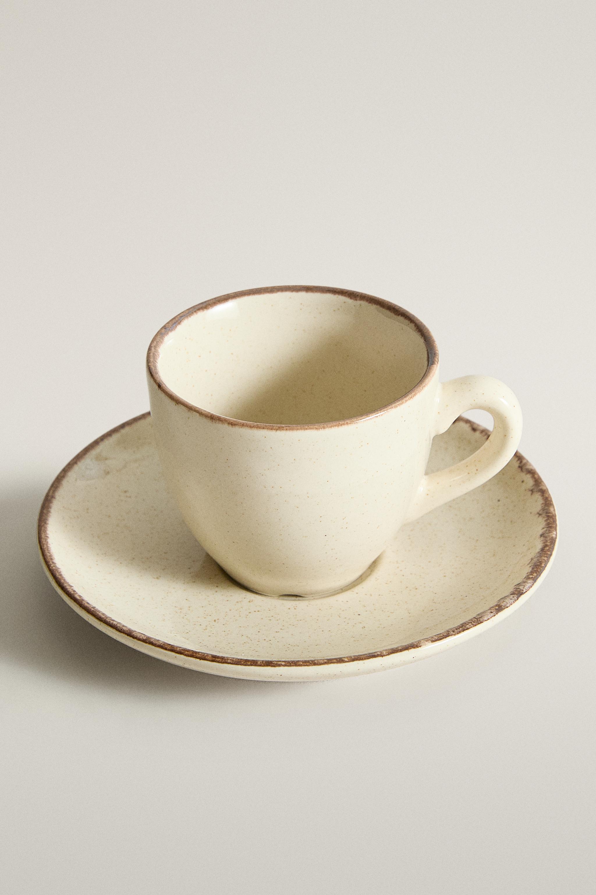STONEWARE COFFEE CUP AND SAUCER WITH DISTRESSED RIM