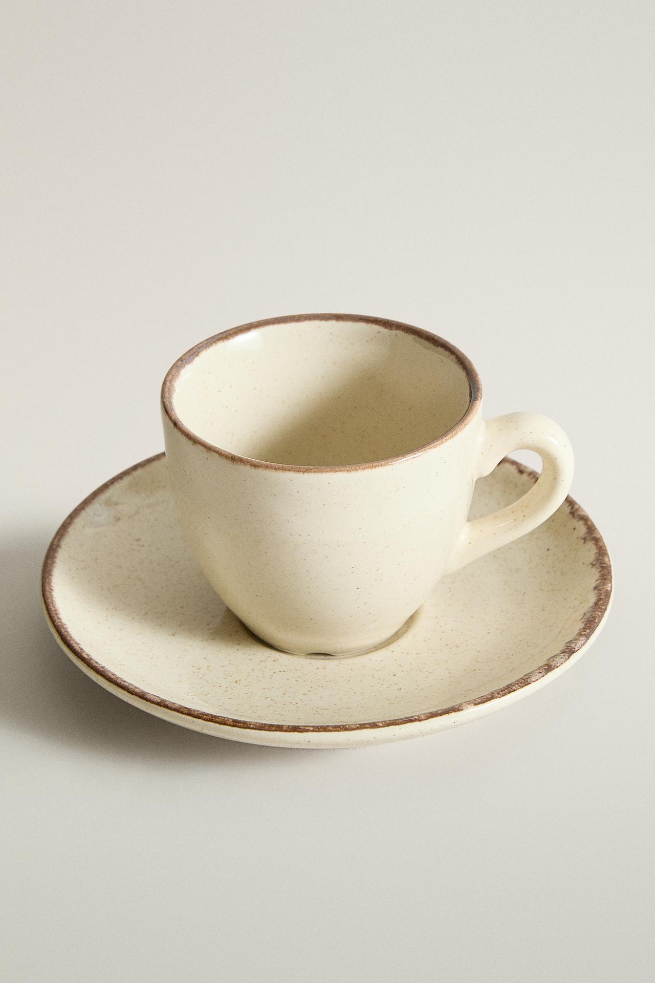 STONEWARE COFFEE CUP AND SAUCER WITH ANTIQUE FINISH RIM — Light ecru