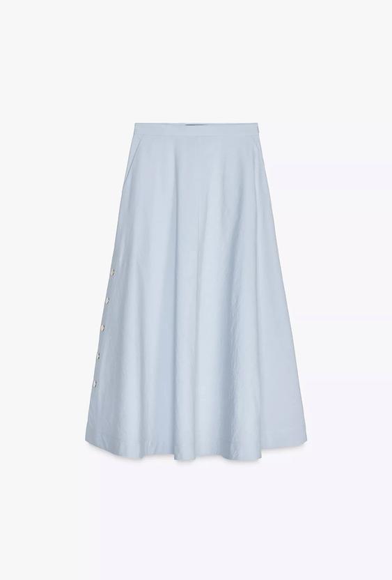 Light blue midi skirt with decorative buttons on the left side, white background.
