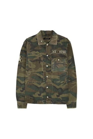 Front view of camouflage jacket with front pockets, text '42-0718' and lapel.