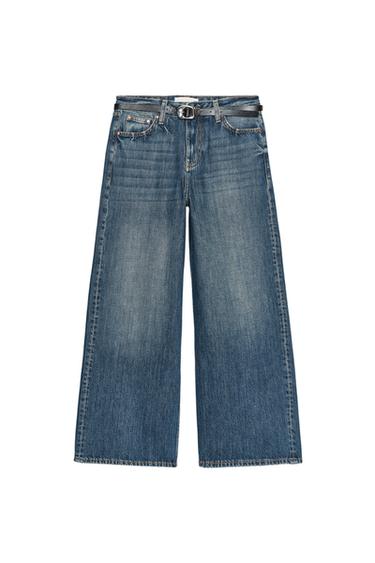 Front view of high-waisted blue jeans with belt, five pockets, and wide, cropped leg. Front zip and button fastening.