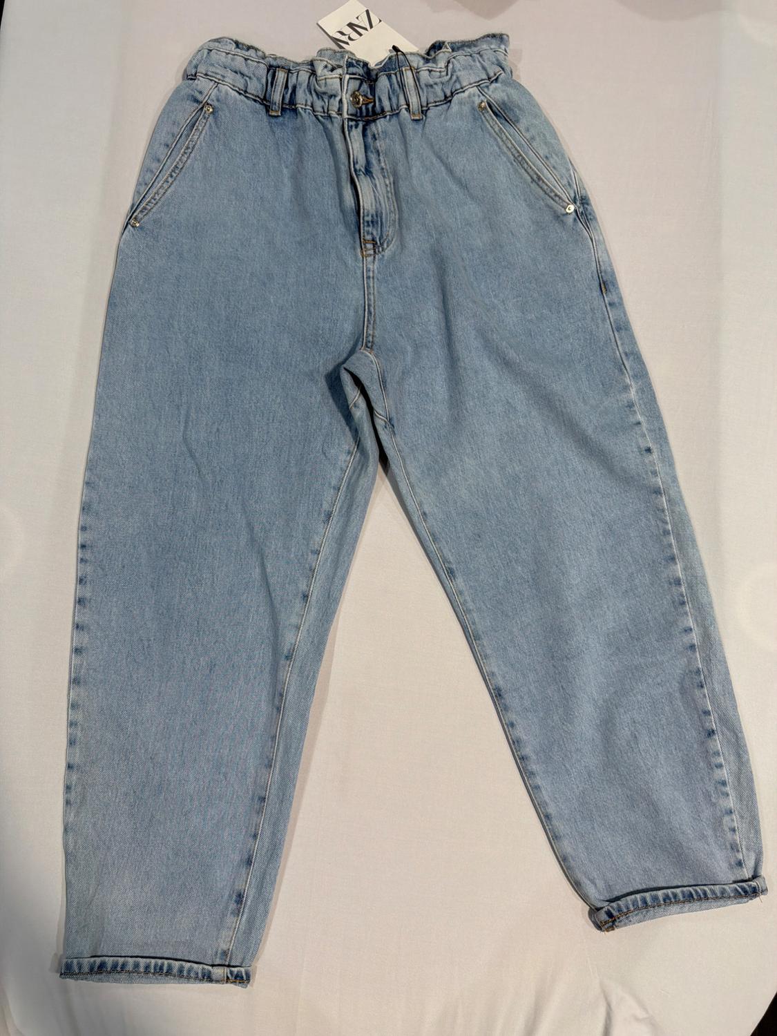 Light blue denim jeans with a gathered elasticated waist, laid out on a white background. Label with the text ZARA at the top.