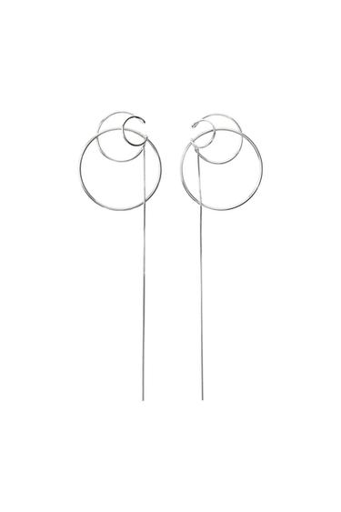 Pair of silver-tone earrings featuring a design of multiple interlocking hoops and a long, fine dangling chain, on a white background.