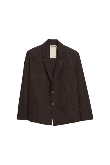 Dark brown jacket with lapels, two buttons and four front pockets. Visible inner label with text.
