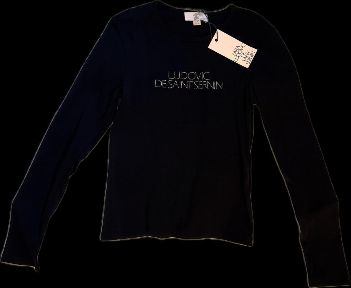 Black long-sleeve T-shirt on a black background. Text: LUDOVIC DE SAINT SERNIN. Label: ZARA LUDOVIC DE SAINT SERNIN.