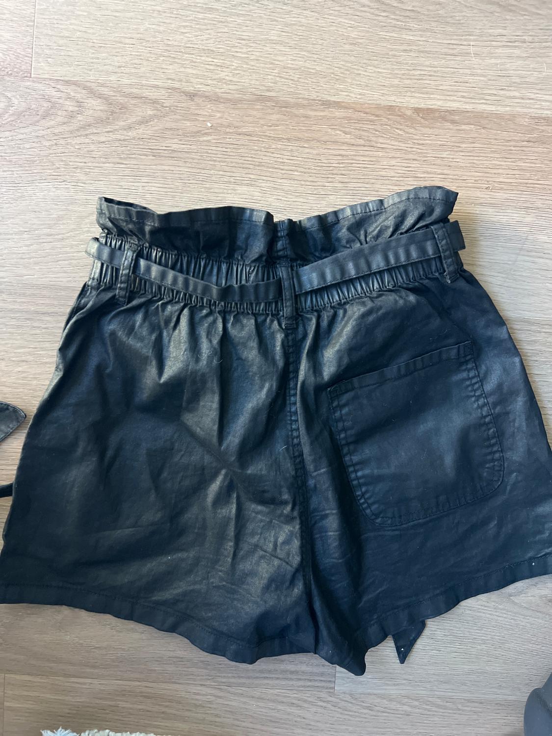 HIGHWAISTED FAUX LEATHER PAPERBAG SHORTS FEATURING A BUTTON FLY AND A MATCHING TIE BELT. - Image 2