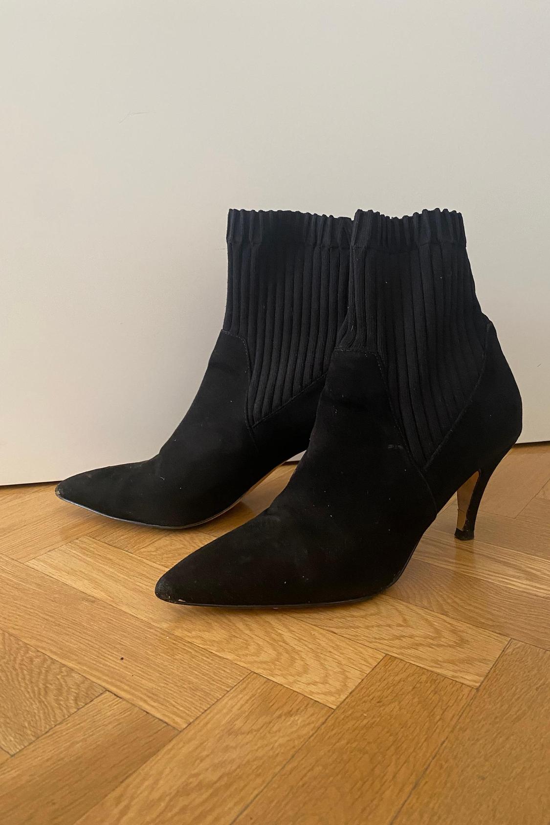 Black low-heeled ankle boots with a ribbed design on the upper.