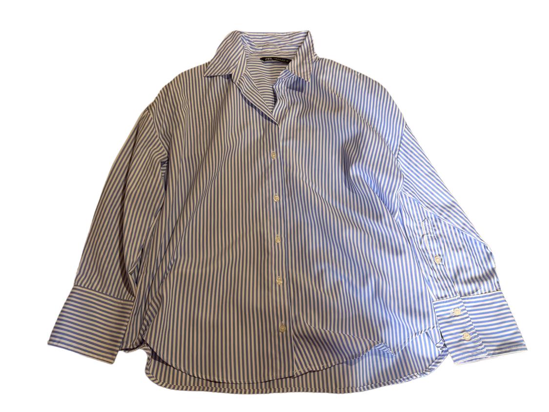 Blue and white striped shirt with a classic collar and front buttons. Long sleeves with buttoned cuffs.