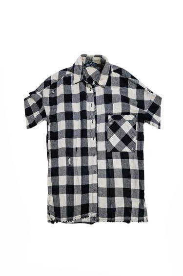 Front view of a black and white checked shirt with a front pocket and buttons.