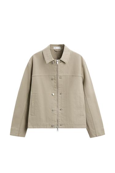 Front view of a beige jacket with zip fastening and side pockets