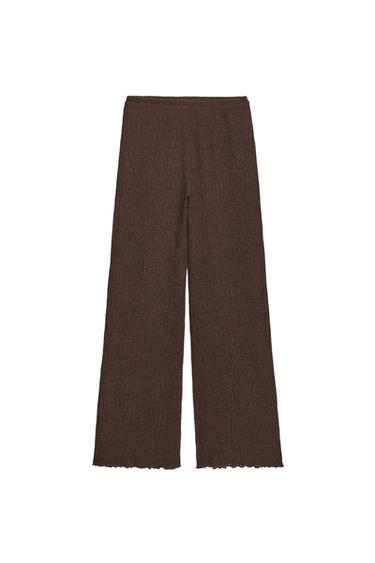 Front view of straight-leg brown trousers with texture, high waist and elasticated waistband.