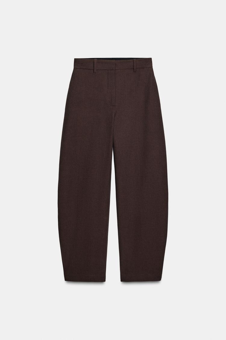 Front view of marl brown trousers with stripes, mid-rise, wide leg, concealed side pockets and front zip fastening.