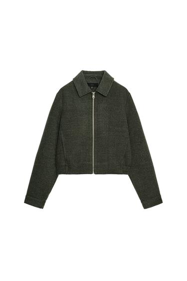 Front view of khaki bomber jacket with shirt collar, long sleeves, front zip pockets and elasticated hem.