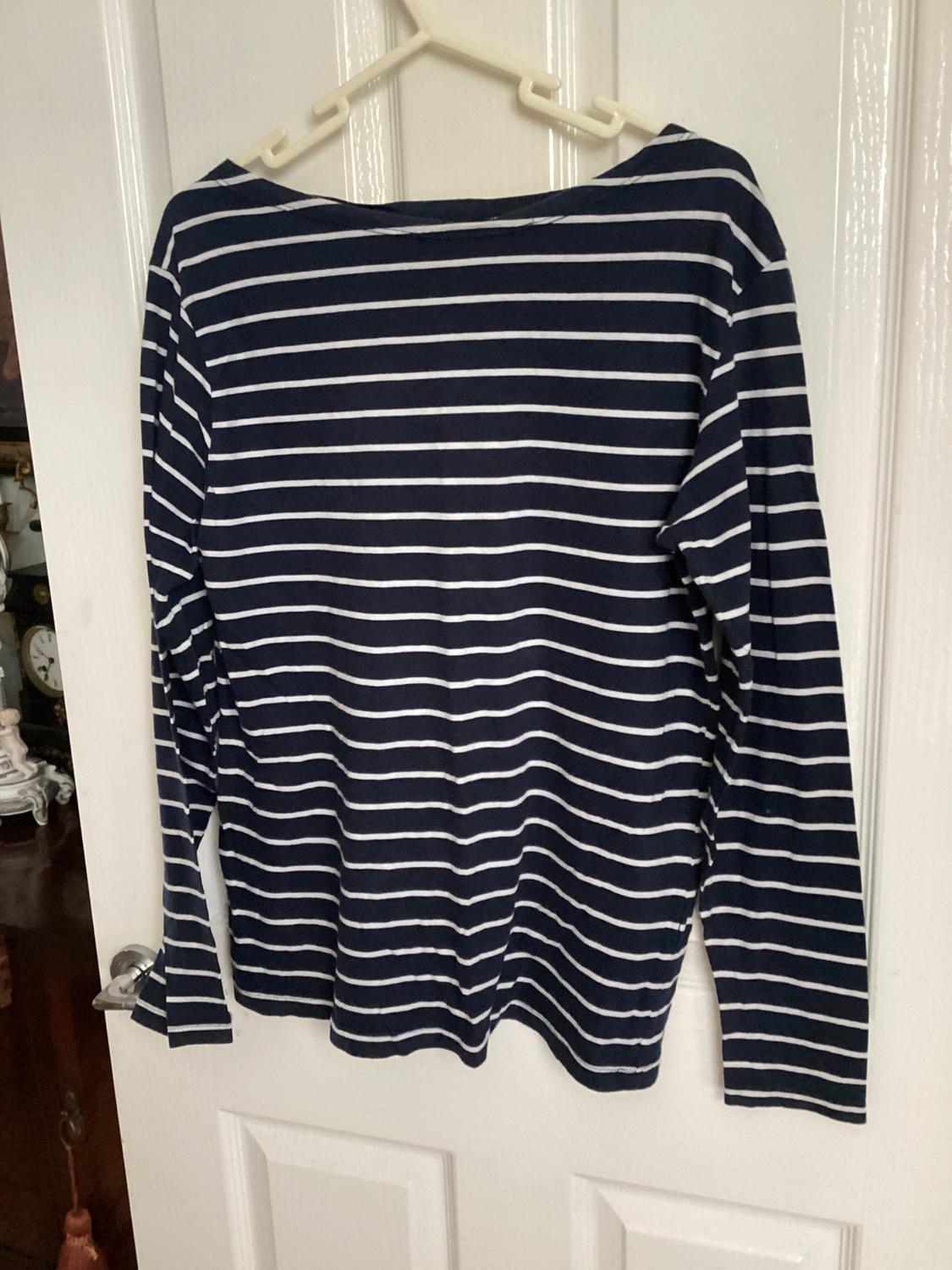 Back view of a navy blue and white striped long-sleeved t-shirt.