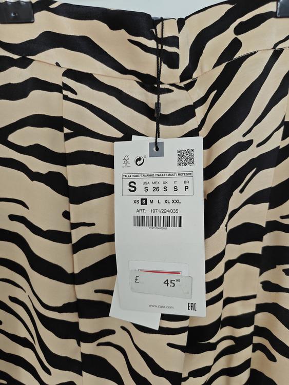 Trousers with black and beige stripe print, swing tag shows size S and price £45.99. Website: www.zara.com.
