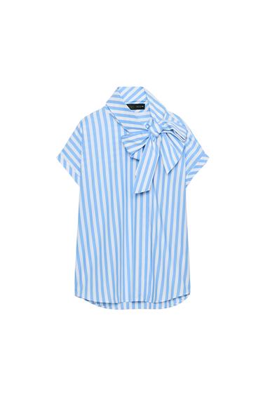 Front view of a blue and white striped shirt, with a high collar and large bow. Short sleeves and a concealed button-front fastening.
