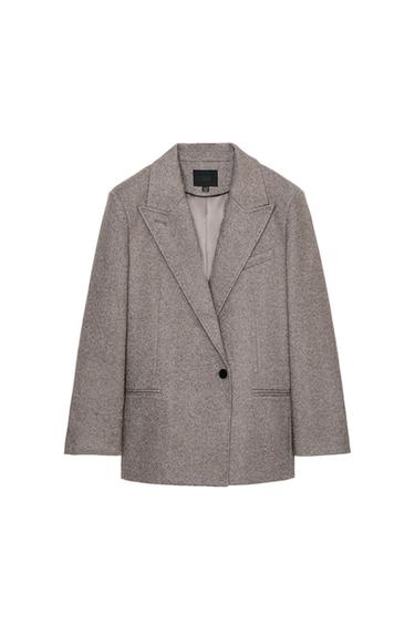 Front view of a taupe blazer with a lapel collar, shoulder pads, jetted pockets and a single-button front fastening.