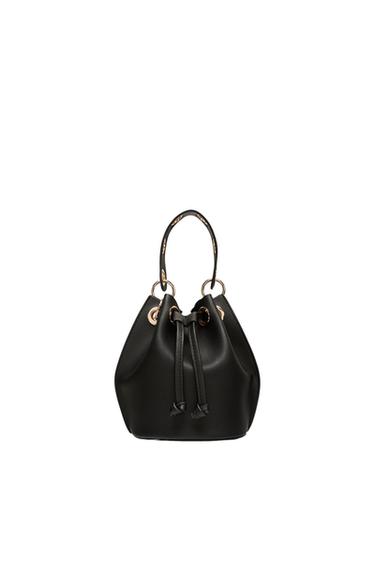 Black handbag with a sack design, adjustable drawstrings, and gold metallic details on a white background.