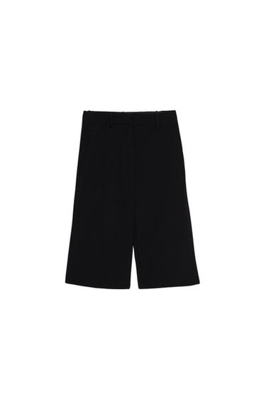 Front view of black Bermuda shorts with side pockets and belt loops.