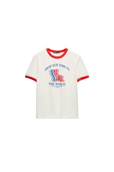 Front view of a white t-shirt with red trim and the text 'FROM NEW YORK TO THE WORLD'.