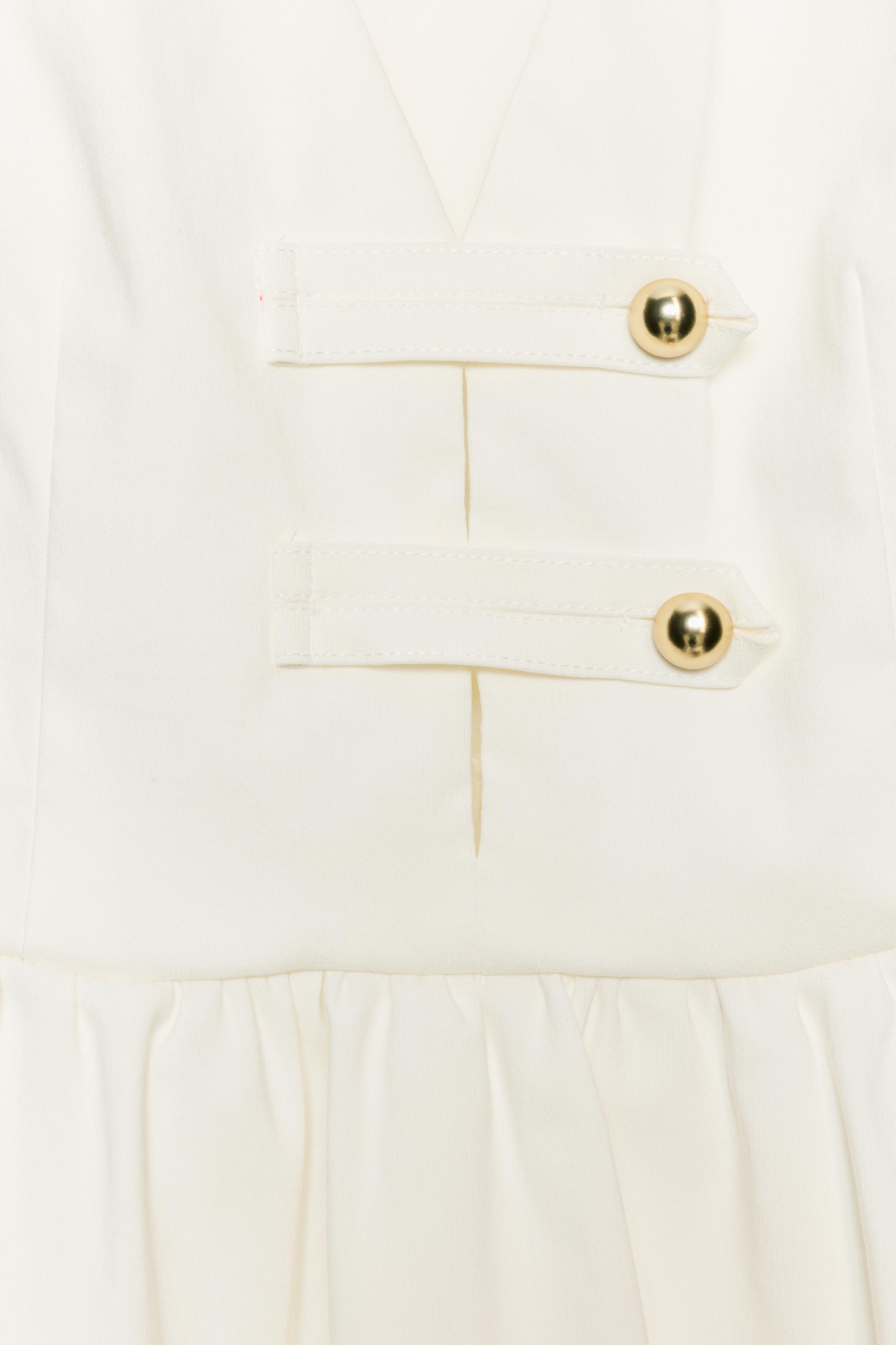 TOP PÉPLUM À BOUTONS DORÉS
