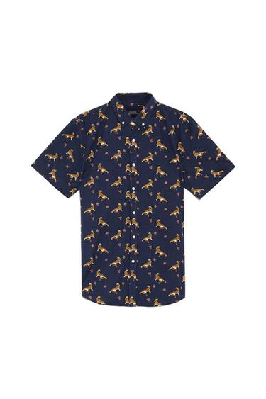 Navy blue short-sleeved shirt with yellow tiger print and red details. White buttons down the front.