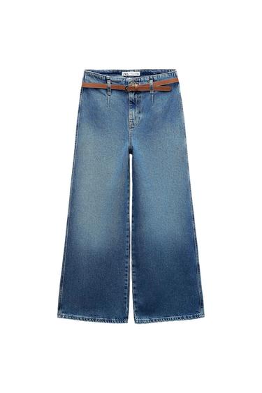 Blue wide-leg denim jeans with front pleats and a brown belt on a white background. Label with the text ZARA.