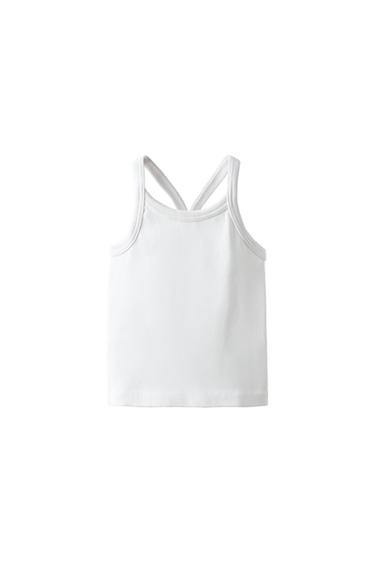 Back view of white tank top with criss-cross straps.
