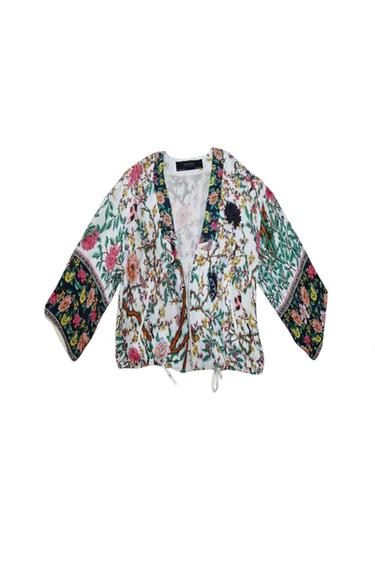 Front view of a colourful floral print jacket with wide sleeves.