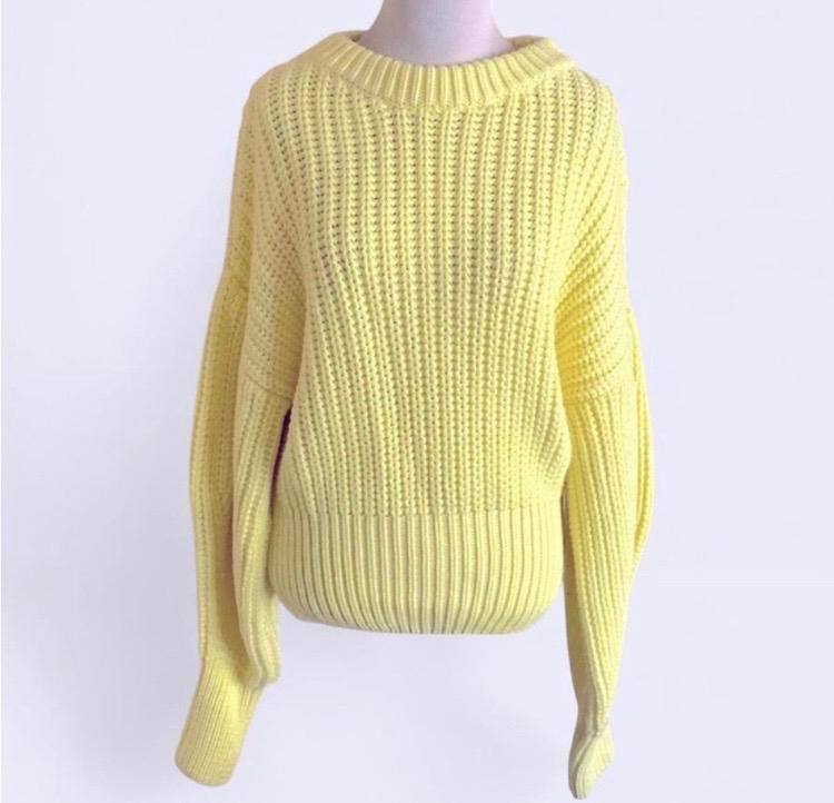 Chunky knit yellow jumper with a crew neck and long sleeves, presented on a white background.