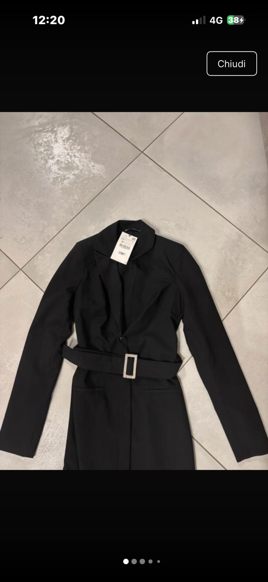 Black blazer with belt and buckle on a tiled floor. Visible text: 12:20, 4G, 38, Close.