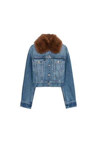 Front view of a cropped mid-blue denim jacket featuring a brown faux-fur effect lapel collar, long sleeves and front flap pockets.