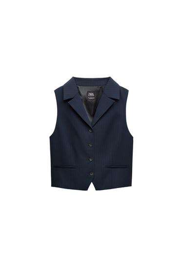 Front view of navy blue vest with buttons and front pockets.