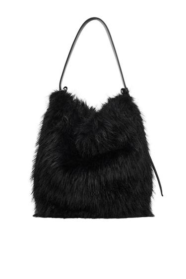 Black textured faux-fur shoulder bag with a slim strap against a white background.