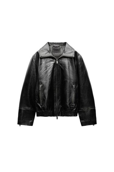 Front view of a black jacket with zipper, side pockets, and wide collar.