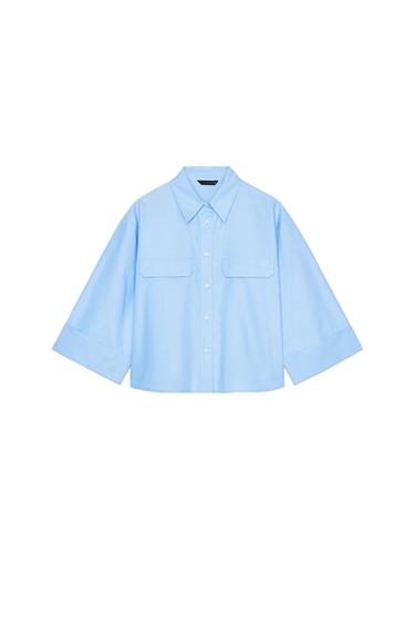 Front view of a light blue shirt with front pockets and long sleeves.