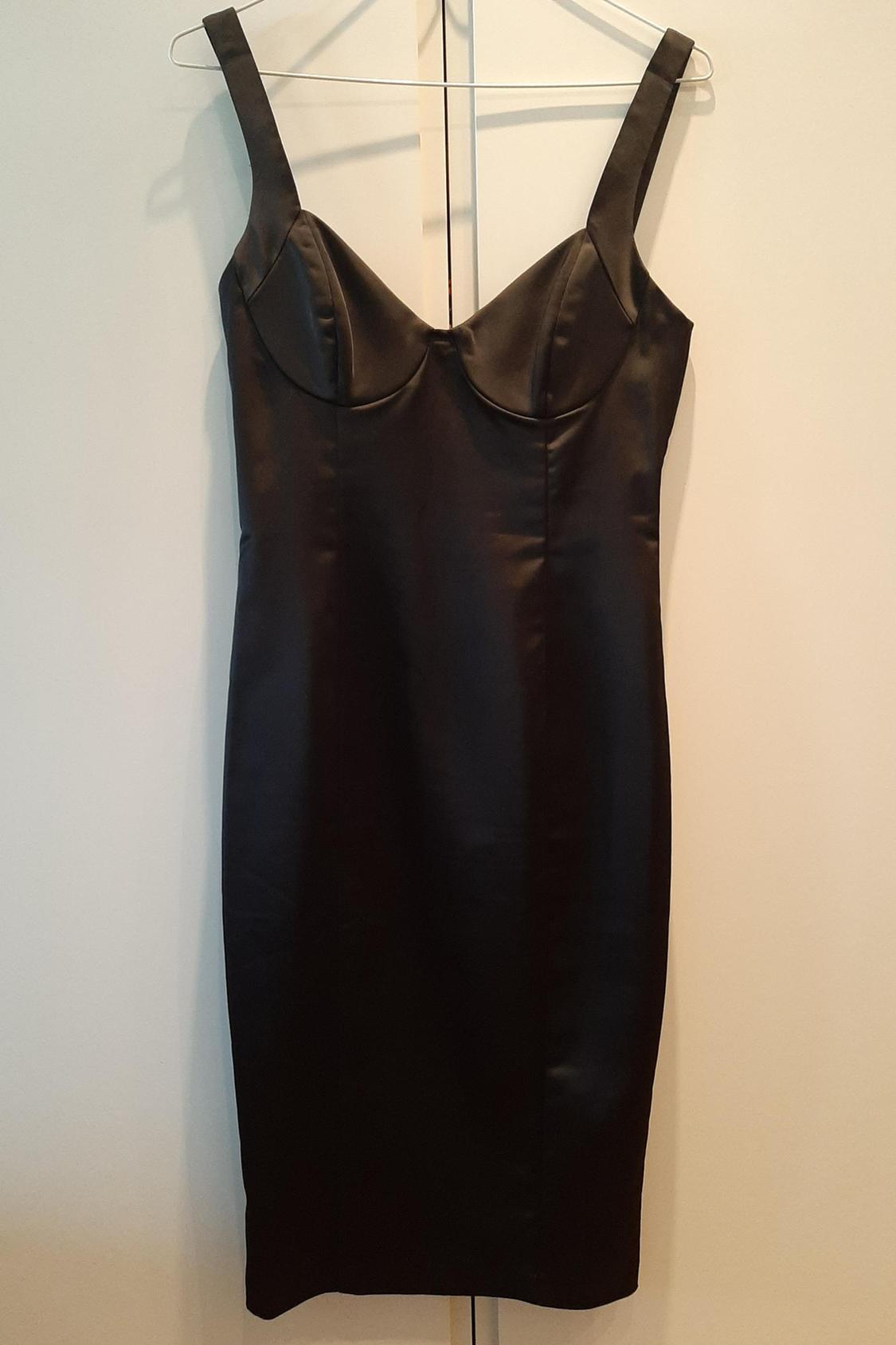 Front view of a black sleeveless dress with a sweetheart neckline.