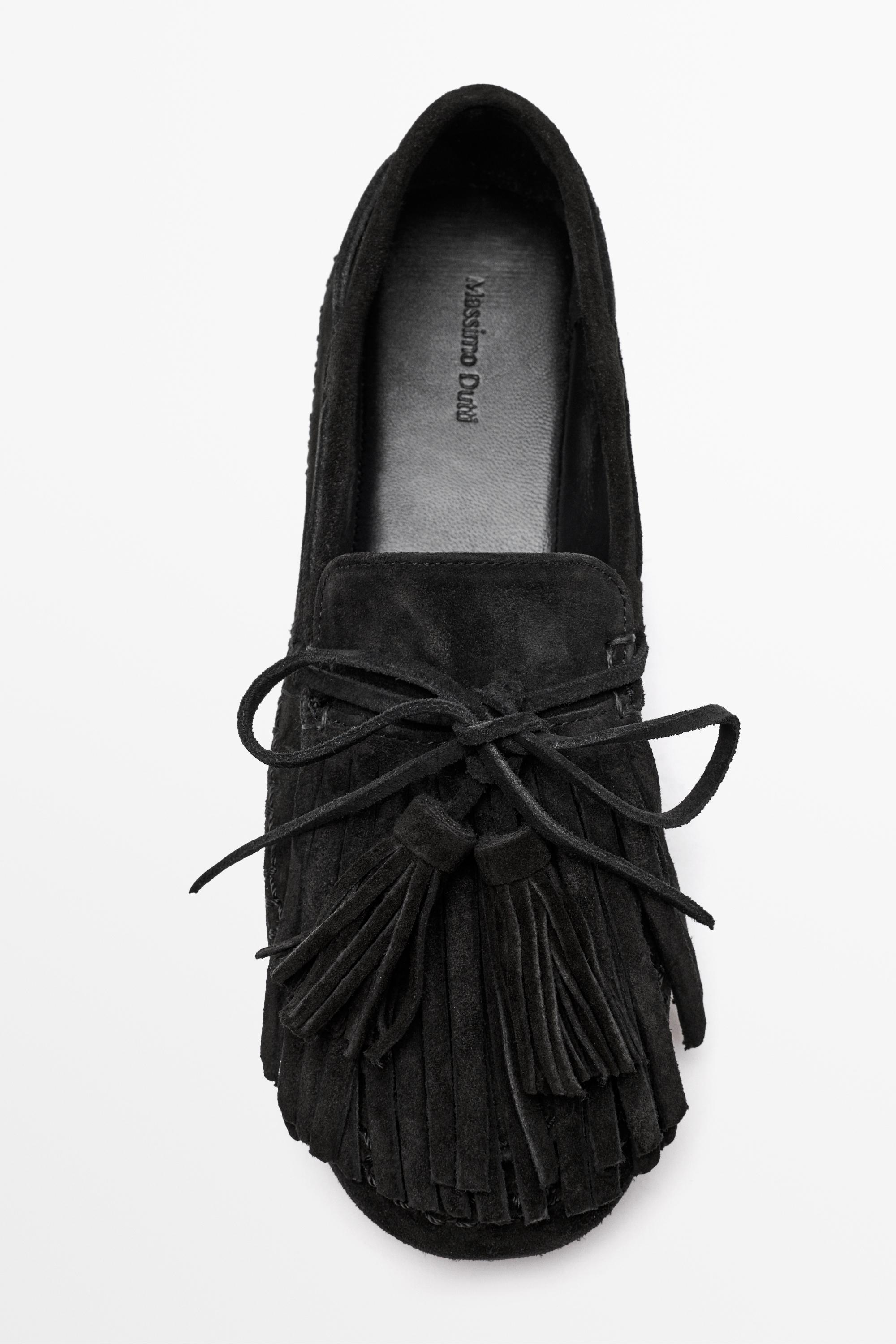 Mocassin en cuir à franges et pompons