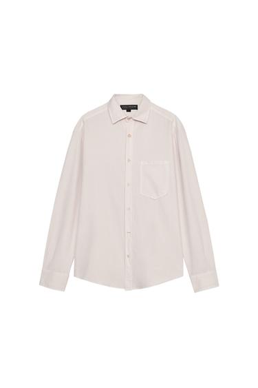 Front view of a white shirt with a front pocket and button fastening.