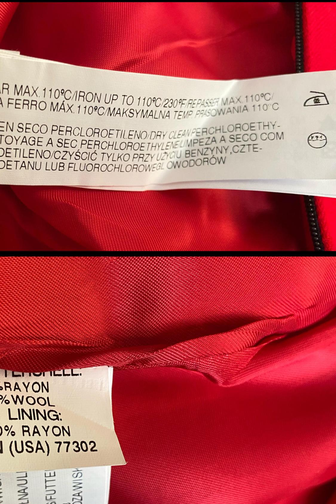 Detail of care label on red garment with washing and ironing instructions.