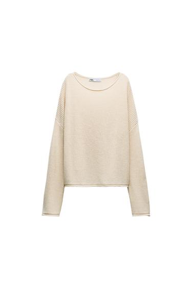 Front view of a beige knit crew neck sweater with long sleeves.