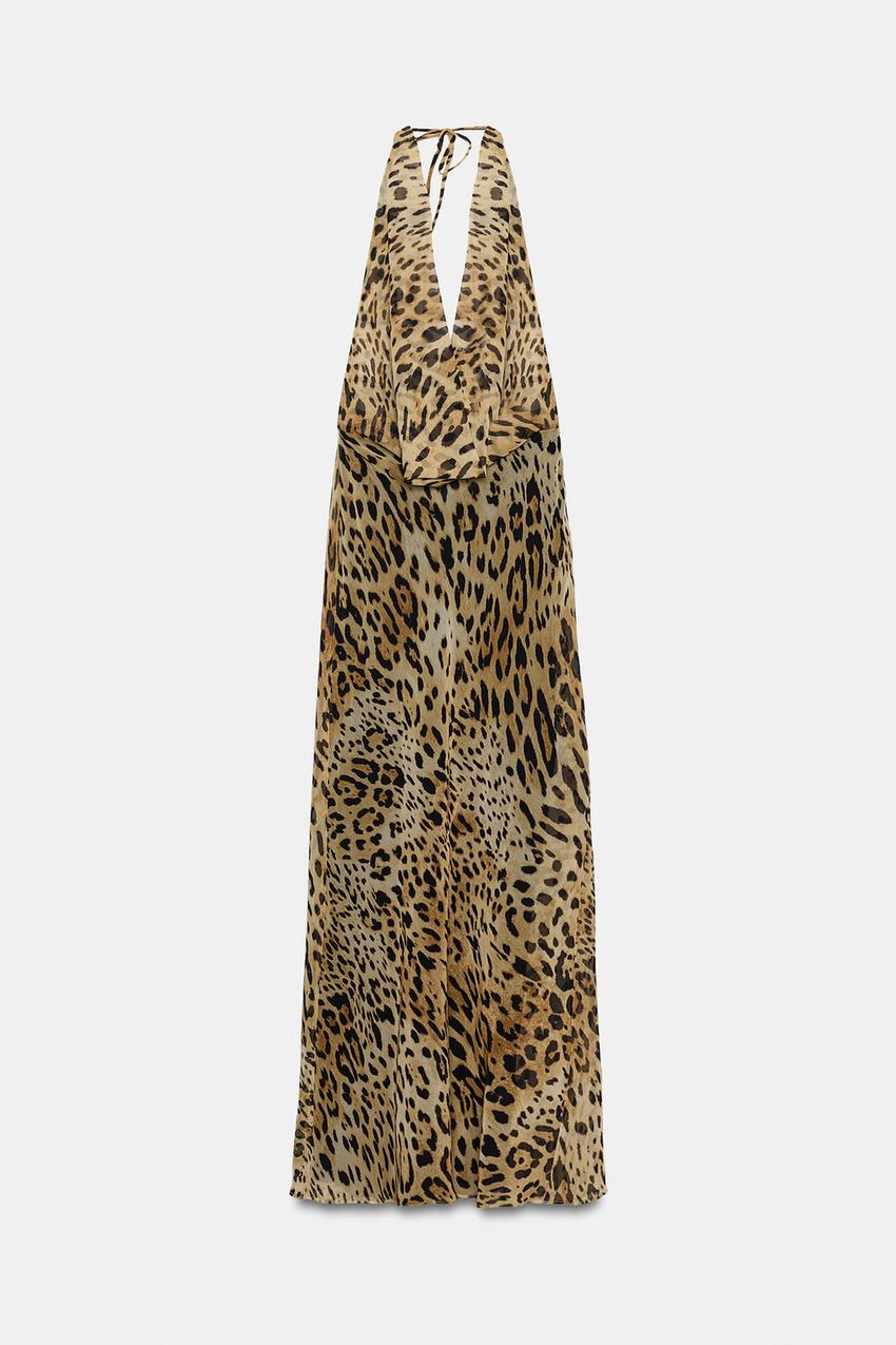 Front view of sleeveless maxi dress with a halter neckline, tie detail, draped neckline, and leopard print.